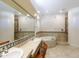 Bright bathroom featuring double sinks and a soaking tub with decorative tile accents, perfect for relaxation at 5949 W Pinnacle Hill Dr, Glendale, AZ 85310
