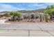 Charming single-story home with mature trees and desert landscaping, complemented by a side driveway at 5949 W Pinnacle Hill Dr, Glendale, AZ 85310