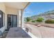 Covered patio with outdoor seating and a view of the landscaped backyard, ideal for enjoying the outdoors at 5949 W Pinnacle Hill Dr, Glendale, AZ 85310