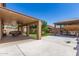 Large covered patio extends to a spacious concrete area, basketball hoop, gazebo, and manicured green space at 6033 W Wood St, Phoenix, AZ 85043