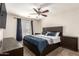 Bedroom with modern furniture and decor, with a ceiling fan, and a window with blinds at 6033 W Wood St, Phoenix, AZ 85043