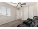 Bright bedroom featuring a ceiling fan, natural light, and closet at 6033 W Wood St, Phoenix, AZ 85043