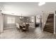 Dining room with tile flooring, ample lighting, and direct access to living room and staircase at 6033 W Wood St, Phoenix, AZ 85043