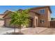 A charming home with a large driveway and a lush tree in the front yard at 6033 W Wood St, Phoenix, AZ 85043