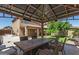 Outdoor gazebo with dining table, view of the backyard and home exterior at 6033 W Wood St, Phoenix, AZ 85043