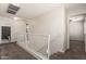 Hallway with a staircase and white railing at 6033 W Wood St, Phoenix, AZ 85043