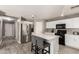 Kitchen with white cabinets, stainless steel appliances, and marble countertop island at 6033 W Wood St, Phoenix, AZ 85043