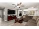 Inviting living room with tile floors, a ceiling fan, and a large, comfortable sectional sofa at 6033 W Wood St, Phoenix, AZ 85043