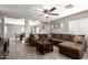 Open living room features tile flooring, a ceiling fan, and comfortable, modern furnishings at 6033 W Wood St, Phoenix, AZ 85043