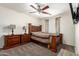 Main bedroom with wood furniture, ceiling fan, and patterned curtains at 6033 W Wood St, Phoenix, AZ 85043