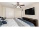 Comfortable main bedroom featuring a ceiling fan, TV, and closet for ample storage space at 6033 W Wood St, Phoenix, AZ 85043