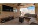 Comfortable patio featuring a TV, built-in speakers, comfortable seating, and outdoor cooking area at 6033 W Wood St, Phoenix, AZ 85043