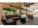 Relaxing patio with comfortable seating, ceiling fans, pool table, and views of the backyard at 6033 W Wood St, Phoenix, AZ 85043