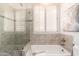 Beautifully designed bathroom with a soaking tub, tiled walls, and plantation shutters for privacy and light at 6135 E Campo Bello Dr, Scottsdale, AZ 85254