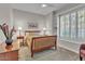 Cozy bedroom with a ceiling fan, plush carpeting, and large windows with plantation shutters at 6135 E Campo Bello Dr, Scottsdale, AZ 85254