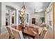 Elegant dining room showcasing a large table, stylish chandelier, and arched doorways to living spaces at 6135 E Campo Bello Dr, Scottsdale, AZ 85254