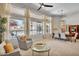 Cozy living room with plush seating, large windows offering backyard pool views, and modern decor at 6135 E Campo Bello Dr, Scottsdale, AZ 85254