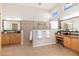 Bright main bathroom with dual vanities, large mirrors, and a glass enclosed shower at 6135 E Campo Bello Dr, Scottsdale, AZ 85254