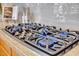 Modern gas stove top with blue flames and light countertops at 6135 E Campo Bello Dr, Scottsdale, AZ 85254