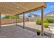 Charming backyard features a covered patio, mature landscaping, and a desert aesthetic at 6602 W Lariat Ln, Phoenix, AZ 85083