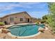 Private backyard featuring a pool, covered patio, and desert-friendly landscaping at 6602 W Lariat Ln, Phoenix, AZ 85083