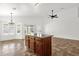 Kitchen with a central island, neutral tile floors, and views of the backyard at 6602 W Lariat Ln, Phoenix, AZ 85083