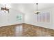 Open-concept living room featuring neutral walls, tile flooring, and natural lighting at 6602 W Lariat Ln, Phoenix, AZ 85083