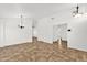 Bright and open living room with neutral tile floors and light fixtures providing ample illumination at 6602 W Lariat Ln, Phoenix, AZ 85083