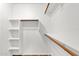 Walk-in closet with wood shelving and ample storage space at 6602 W Lariat Ln, Phoenix, AZ 85083