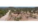 Expansive aerial view of desert property, showcasing a home with surrounding native vegetation and mountain views at 6608 E Ranch Rd, Cave Creek, AZ 85331