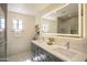 Modern bathroom with double sink vanity, sleek lighting, and a stylish glass-enclosed shower at 6608 E Ranch Rd, Cave Creek, AZ 85331