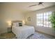 Cozy bedroom featuring a neutral palette, plush bedding, and a scenic outdoor view from a large window at 6608 E Ranch Rd, Cave Creek, AZ 85331