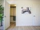 View of closet with custom shelving, plus a modern painting and two bright white doors at 6608 E Ranch Rd, Cave Creek, AZ 85331