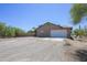 Exterior view of a home with a large garage and a spacious driveway at 6608 E Ranch Rd, Cave Creek, AZ 85331