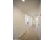 Hallway featuring wood floors and access to a sun-filled bathroom with a modern vanity at 6608 E Ranch Rd, Cave Creek, AZ 85331