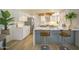 Well-lit kitchen with stainless steel appliances, white cabinetry, and a breakfast bar at 6608 E Ranch Rd, Cave Creek, AZ 85331