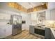 Bright kitchen with stainless steel appliances, white cabinets, and unique ceiling accent at 6608 E Ranch Rd, Cave Creek, AZ 85331