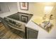 Close-up of a modern stovetop on a kitchen counter with gray cabinets at 6608 E Ranch Rd, Cave Creek, AZ 85331