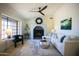 Cozy living room boasts a decorative fireplace, plush seating, and abundant natural light at 6608 E Ranch Rd, Cave Creek, AZ 85331
