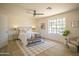 Bright primary bedroom with neutral tones, a ceiling fan, and a large window at 6608 E Ranch Rd, Cave Creek, AZ 85331