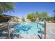 Inviting pool with stone surround and a lush desert landscape under a clear blue sky at 6608 E Ranch Rd, Cave Creek, AZ 85331