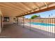 Covered patio providing shade and a view of the fenced in in-ground pool, perfect for entertaining at 662 W Laguna Azul Ave, Mesa, AZ 85210