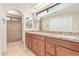 Elegant bathroom featuring a double vanity, granite countertops, and a tiled shower at 662 W Laguna Azul Ave, Mesa, AZ 85210