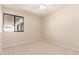 Bright, carpeted bedroom with a ceiling fan and large window that fills the room with plenty of light at 662 W Laguna Azul Ave, Mesa, AZ 85210