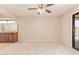 Inviting bedroom with a ceiling fan, beige carpet, and a view of the pool at 662 W Laguna Azul Ave, Mesa, AZ 85210