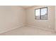 Comfortable bedroom with neutral carpet and a window offering neighborhood views at 662 W Laguna Azul Ave, Mesa, AZ 85210