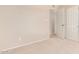 Bedroom with closet and open doorway, neutral walls and carpet, bright and spacious at 662 W Laguna Azul Ave, Mesa, AZ 85210