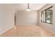 Bright dining room with tile floors, natural light, and a view of the neighborhood at 662 W Laguna Azul Ave, Mesa, AZ 85210