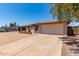Charming single-story home with a well-maintained yard and a spacious two-car garage at 662 W Laguna Azul Ave, Mesa, AZ 85210