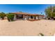 Attractive home with a desert-style front yard, lush green landscaping, and a two-car garage at 662 W Laguna Azul Ave, Mesa, AZ 85210
